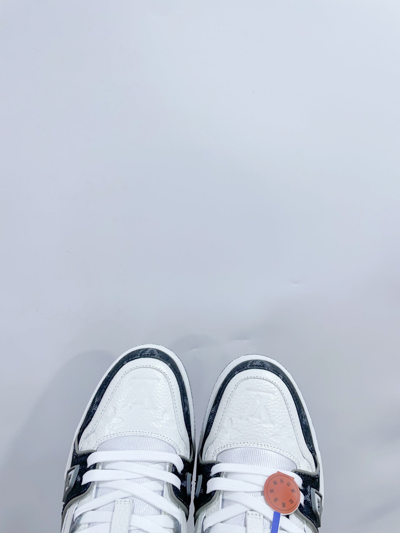 LV TRAINER SNEAKER IN WHITE CALFSKIN AND BLACK MONOGRAM DENIM