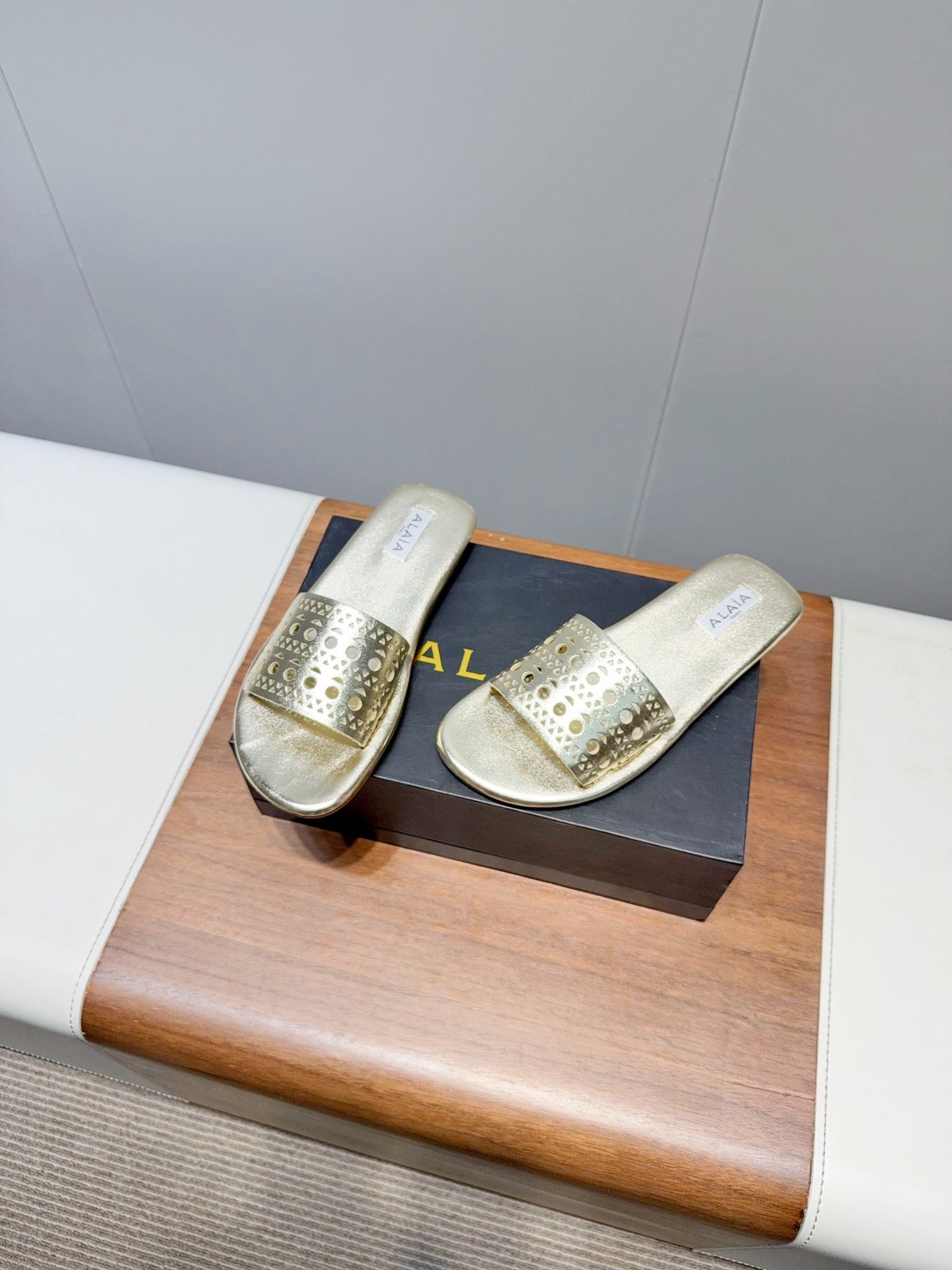 ALAIA FLAT SANDALS WITH PERFORATED STRAPS 25S IN GOLD LAMBSKIN