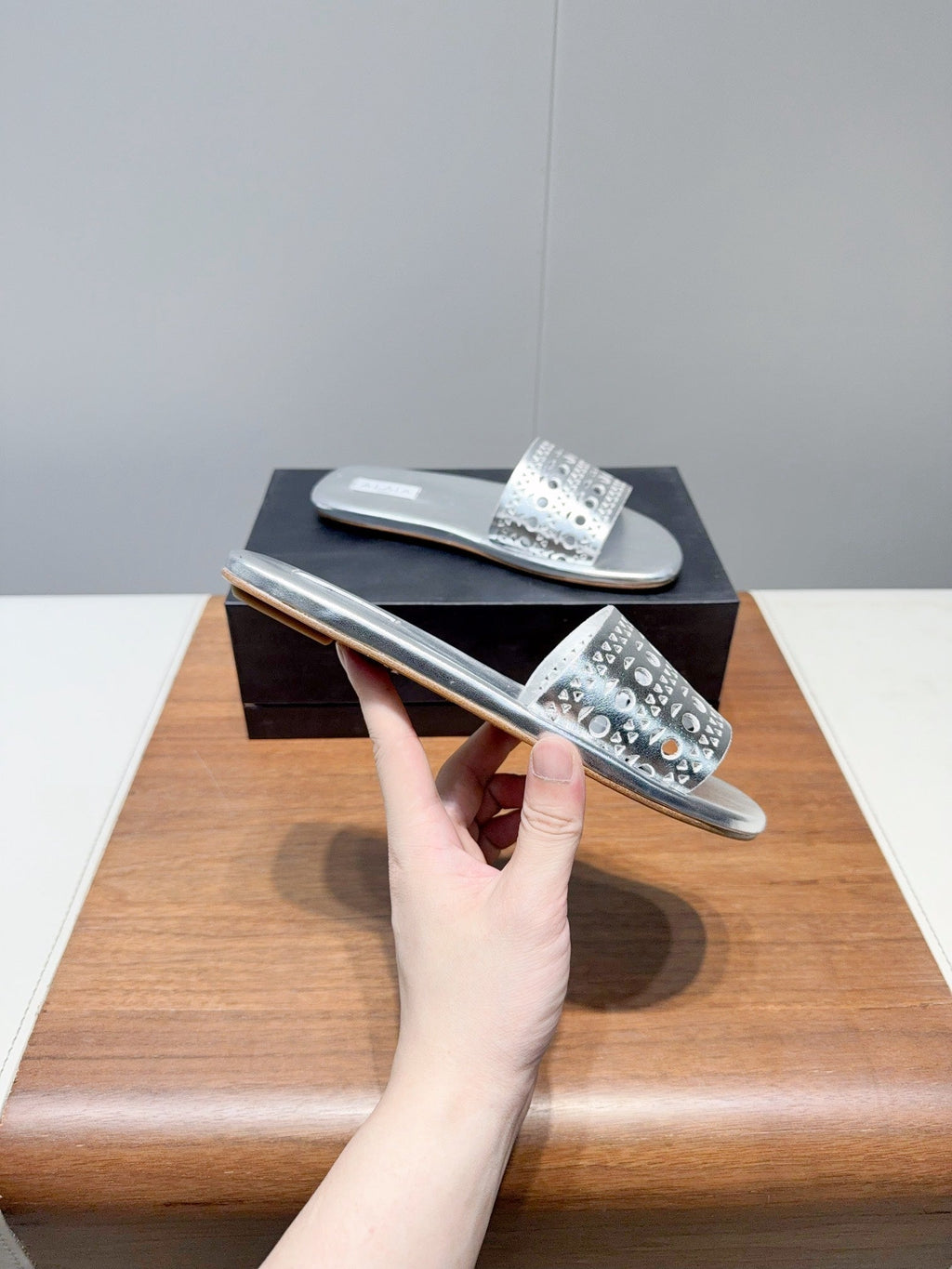 ALAIA FLAT SANDALS WITH PERFORATED STRAPS 25S IN SILVER LAMBSKIN