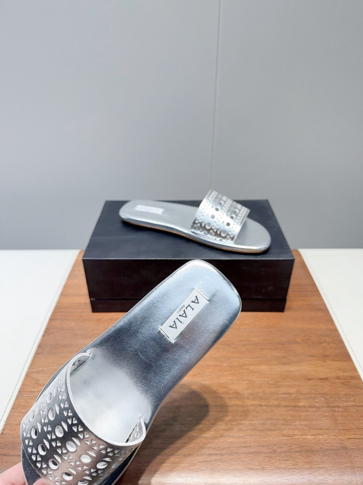 ALAIA FLAT SANDALS WITH PERFORATED STRAPS 25S IN SILVER LAMBSKIN