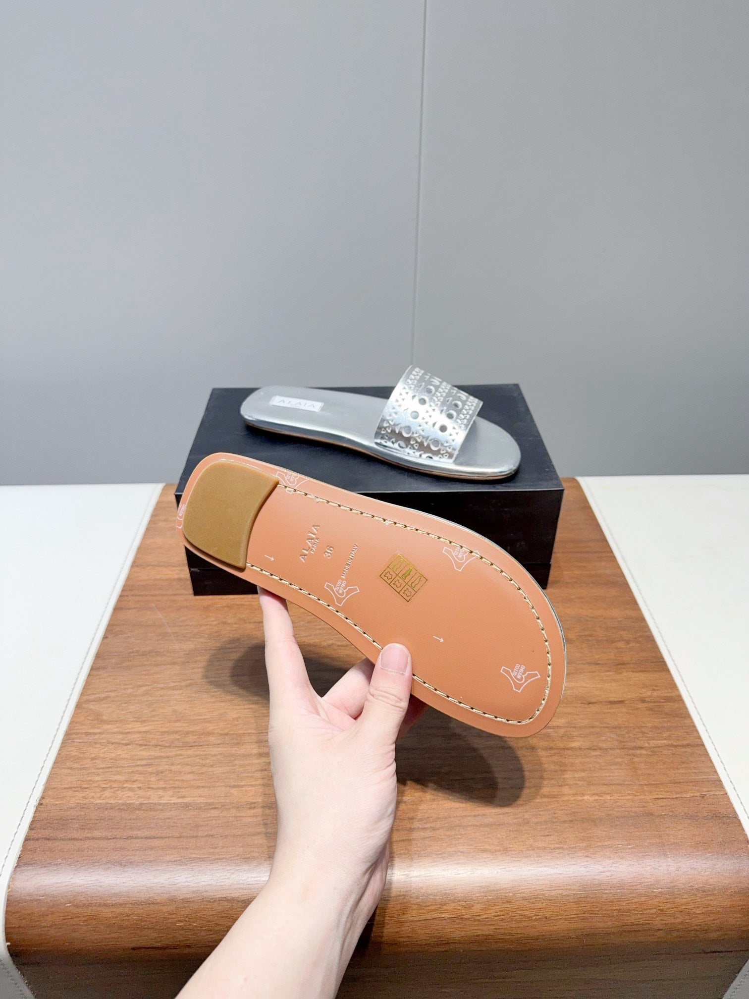 ALAIA FLAT SANDALS WITH PERFORATED STRAPS 25S IN SILVER LAMBSKIN