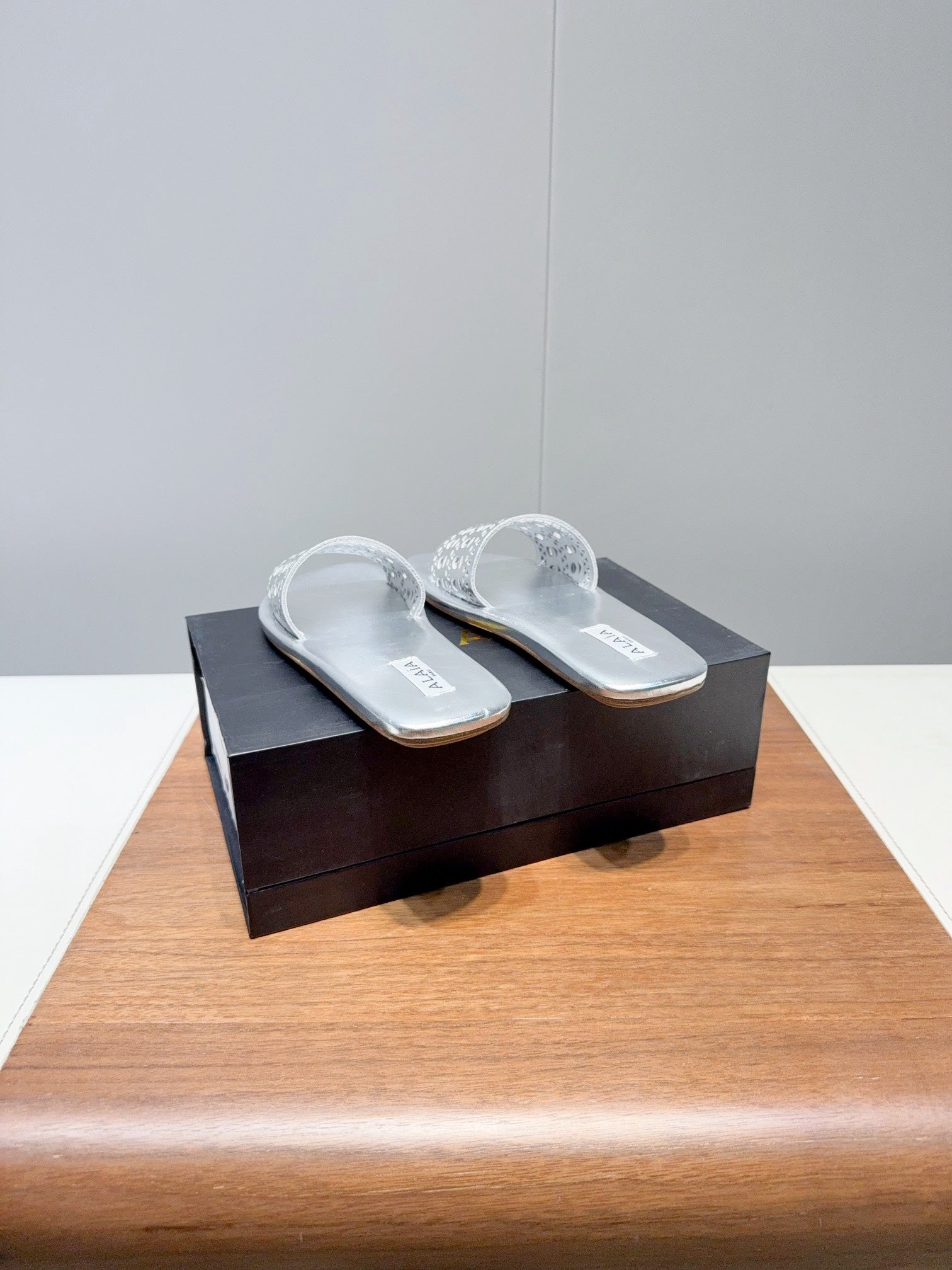 ALAIA FLAT SANDALS WITH PERFORATED STRAPS 25S IN SILVER LAMBSKIN