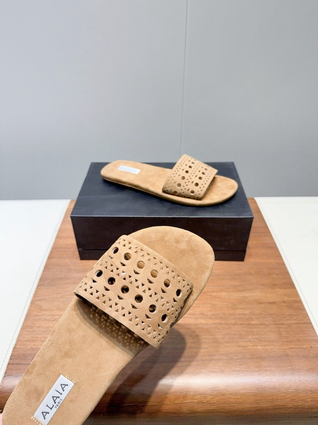 ALAIA FLAT SANDALS WITH PERFORATED STRAPS 25S IN BEIGE SUEDE