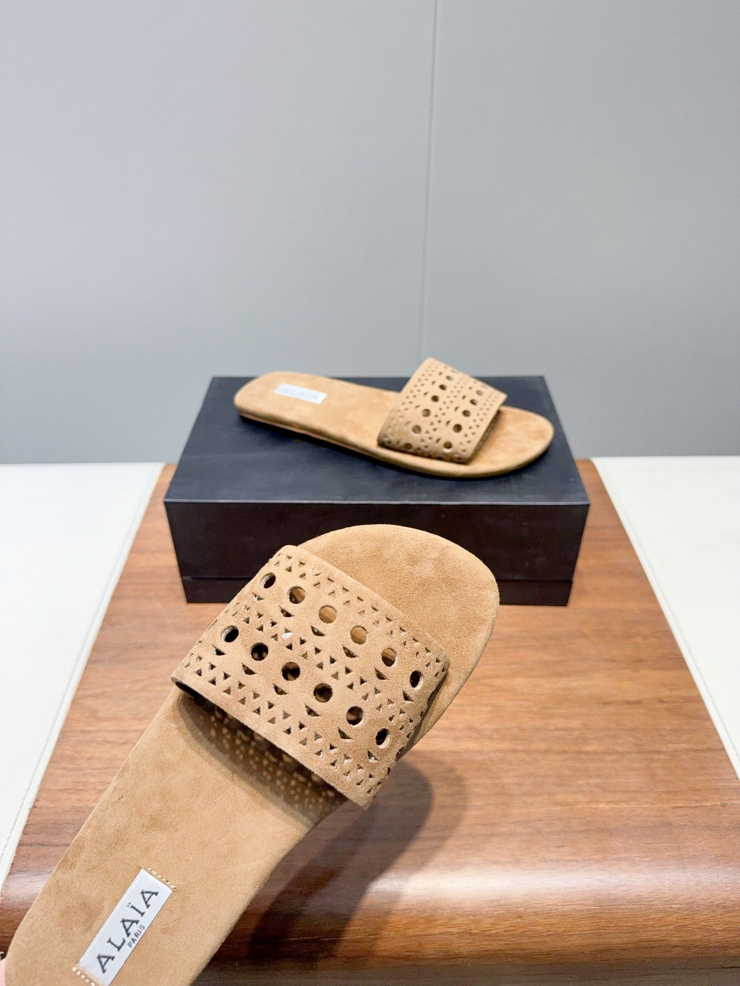 ALAIA FLAT SANDALS WITH PERFORATED STRAPS 25S IN BEIGE SUEDE