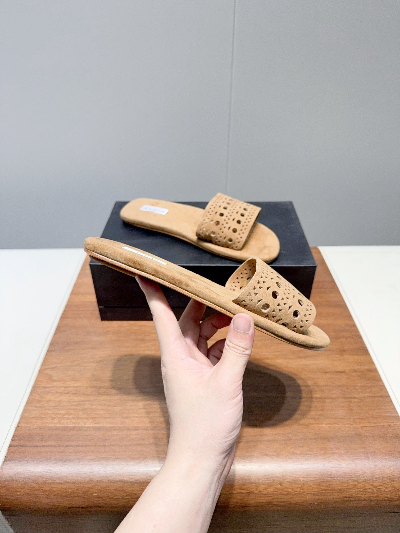 ALAIA FLAT SANDALS WITH PERFORATED STRAPS 25S IN BEIGE SUEDE