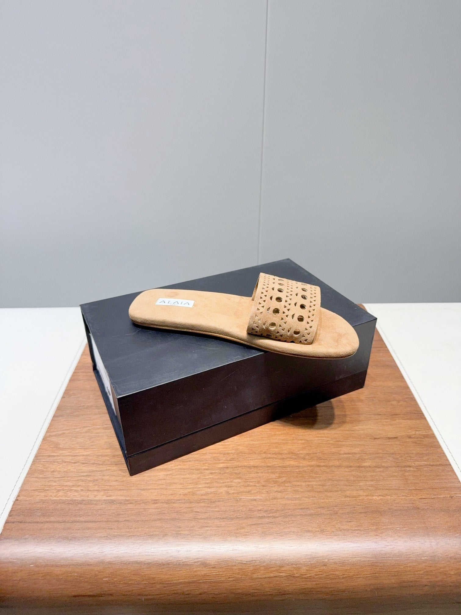 ALAIA FLAT SANDALS WITH PERFORATED STRAPS 25S IN BEIGE SUEDE