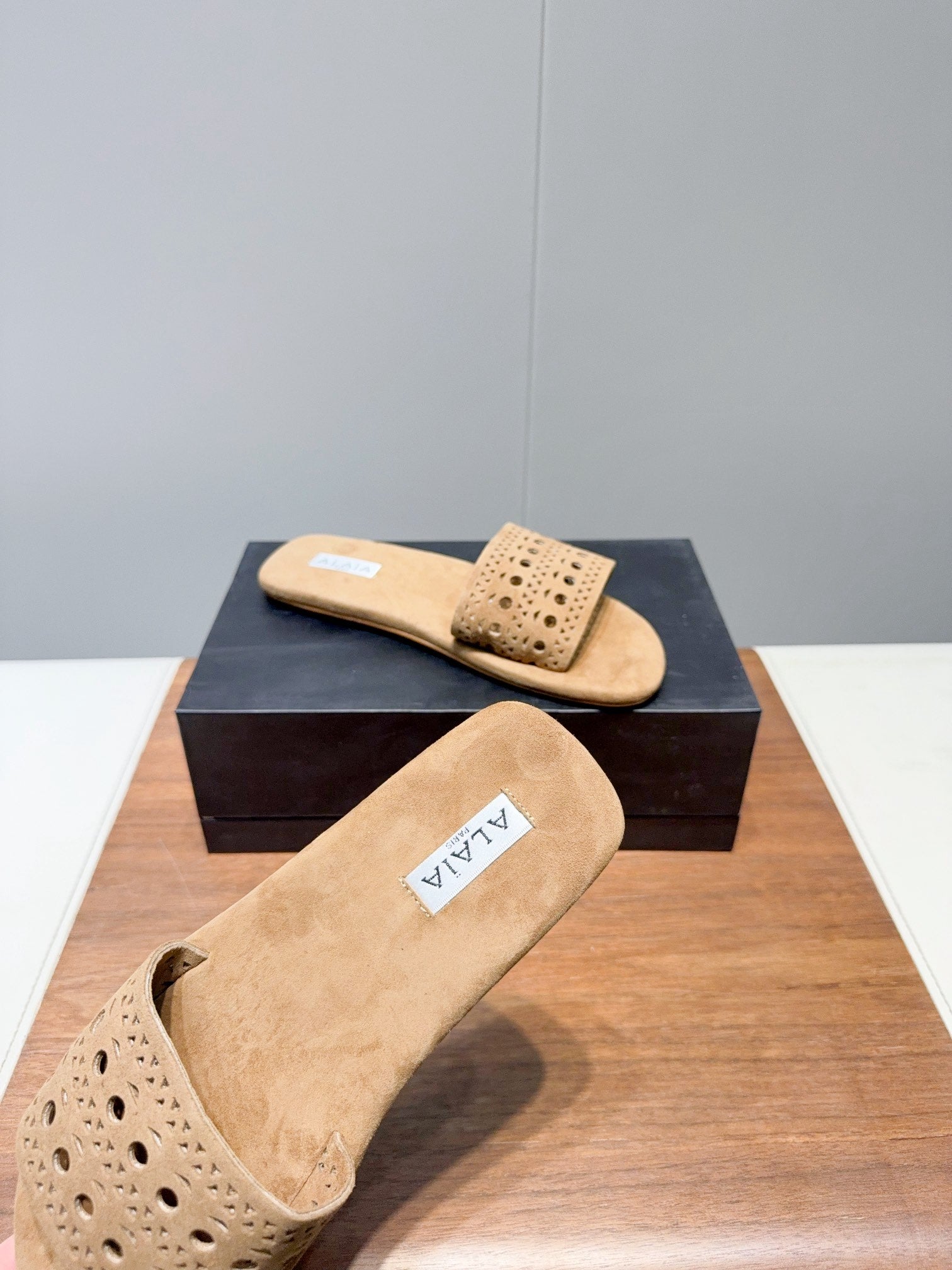 ALAIA FLAT SANDALS WITH PERFORATED STRAPS 25S IN BEIGE SUEDE