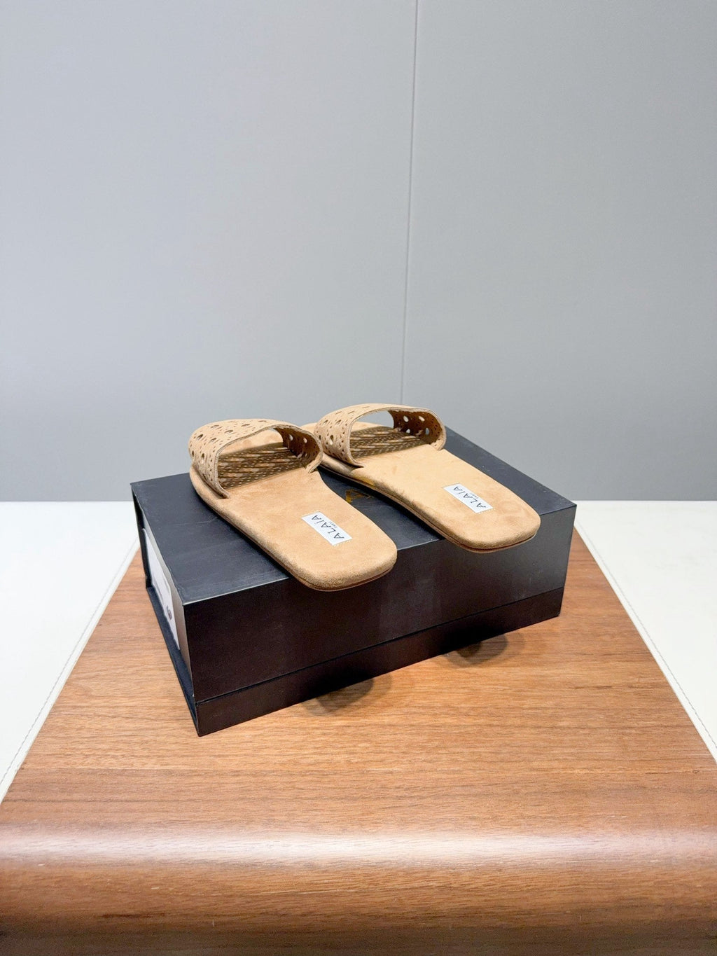 ALAIA FLAT SANDALS WITH PERFORATED STRAPS 25S IN BEIGE SUEDE