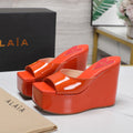 ALAIA PLATFORM WEDGE IN VIVID ORANGE LAMBSKIN WITH RED HEART