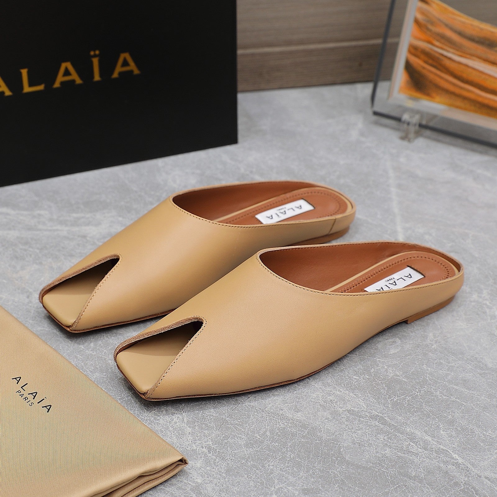 ALAIA FLAT MULE IN SEPIA TAN LAMBSKIN