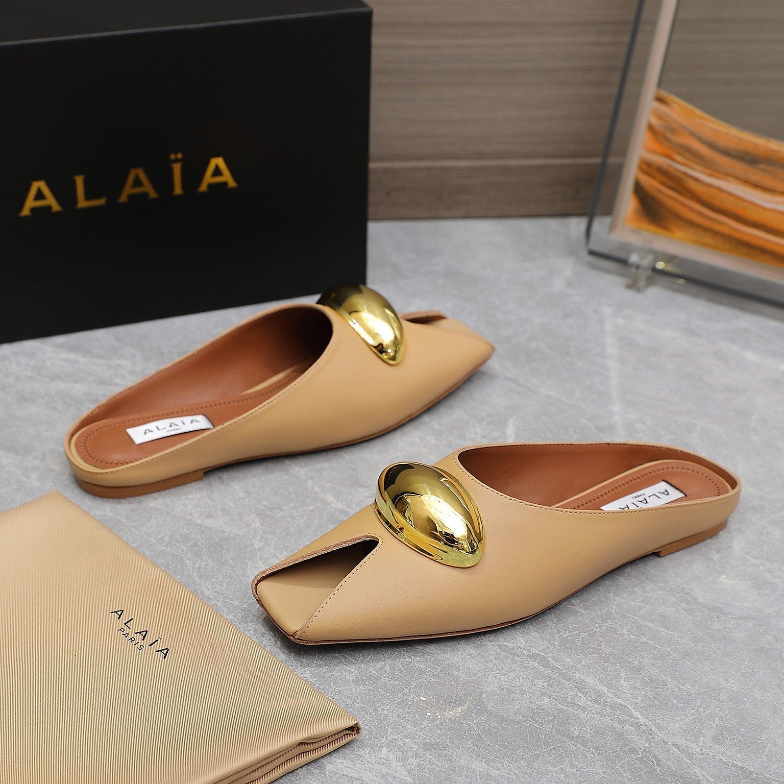 ALAIA FLAT MULE IN SEPIA TAN LAMBSKIN WITH GOLD HARDWARE