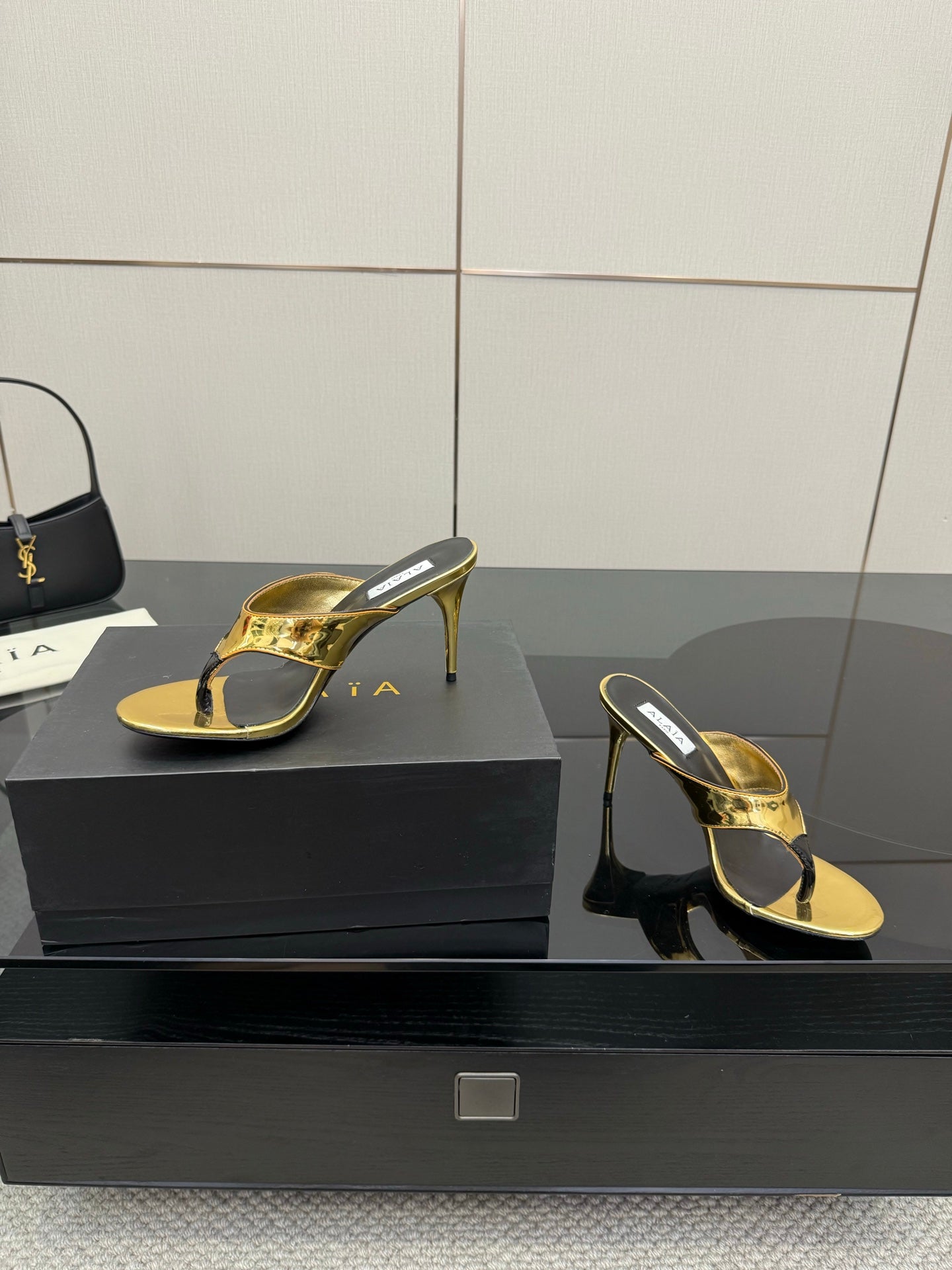 ALAIA HEELED THONG 25S IN GOLD PATENT LEATHER