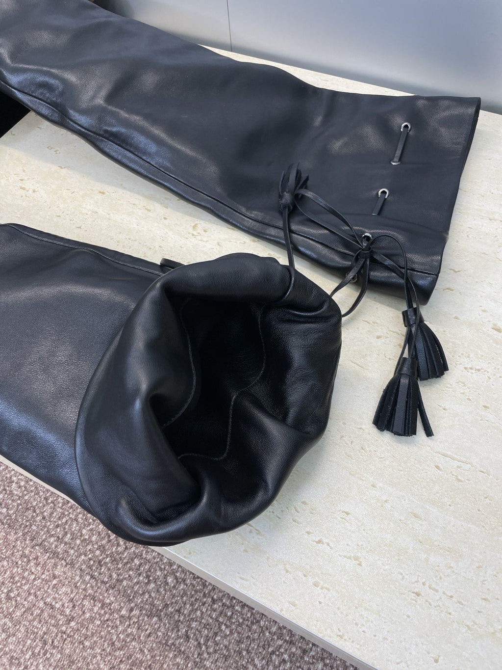 YSL 25S HIGH‑HEEL FRINGED MARTIN BOOTS 90 MM IN BLACK LAMBSKIN