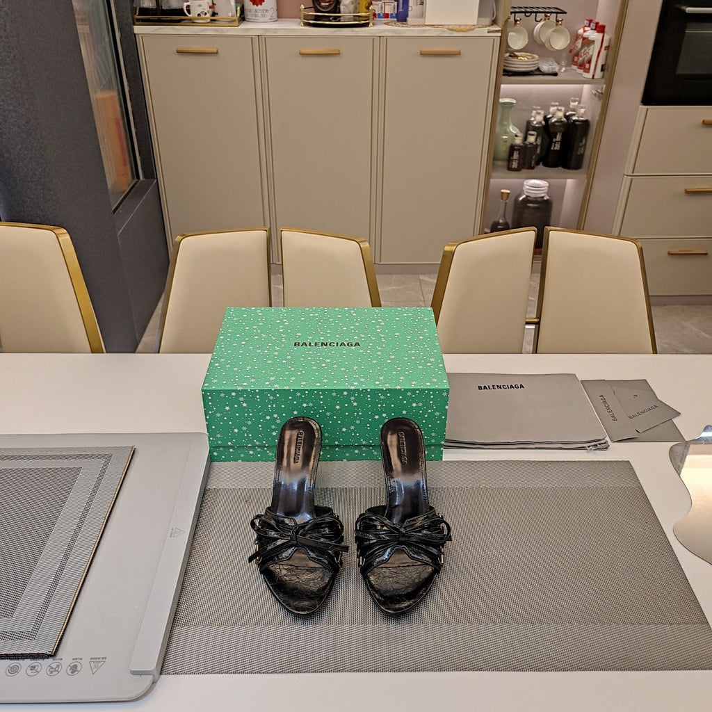 BOW-EMBELLISHED HIGH MULES IN BLACK SHEEPSKIN