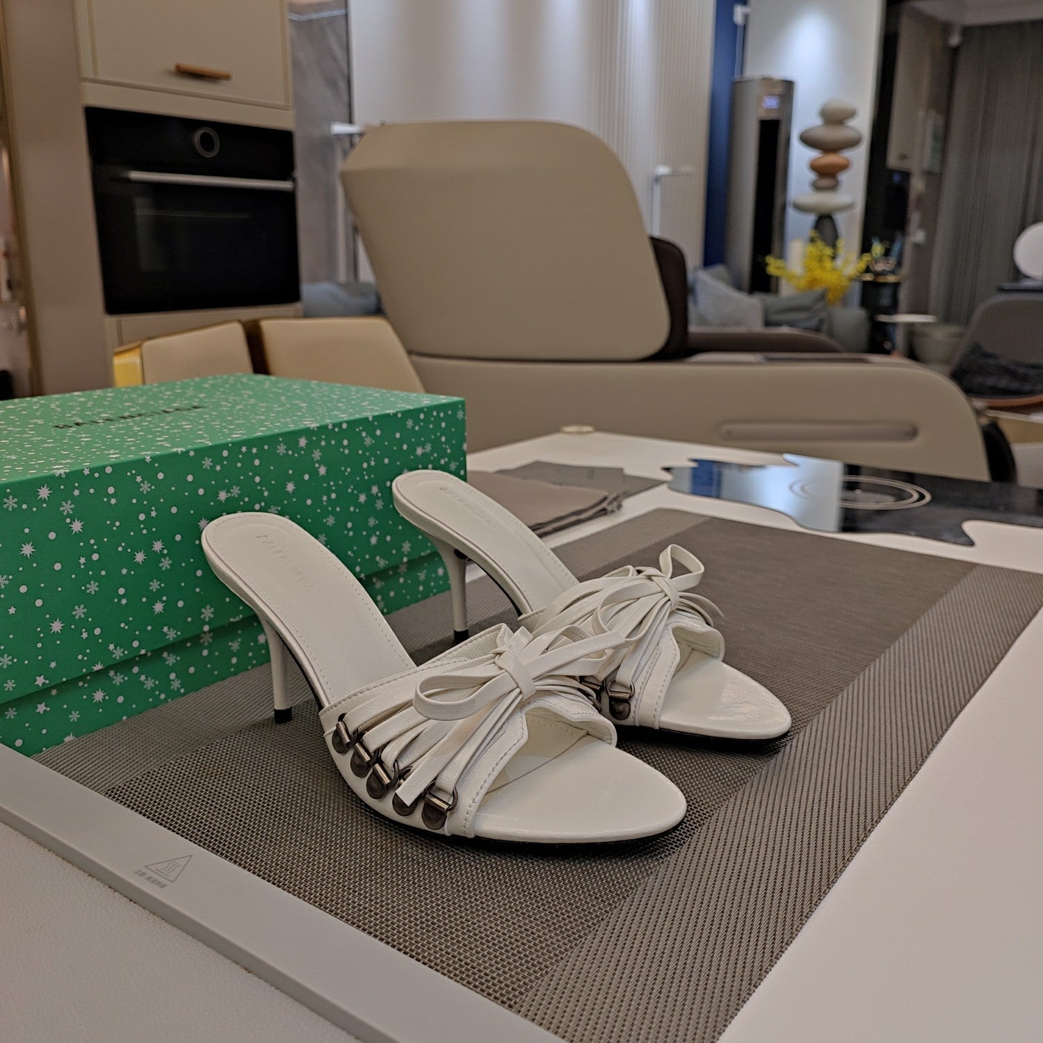 BOW-EMBELLISHED HIGH MULES IN WHITE SHEEPSKIN