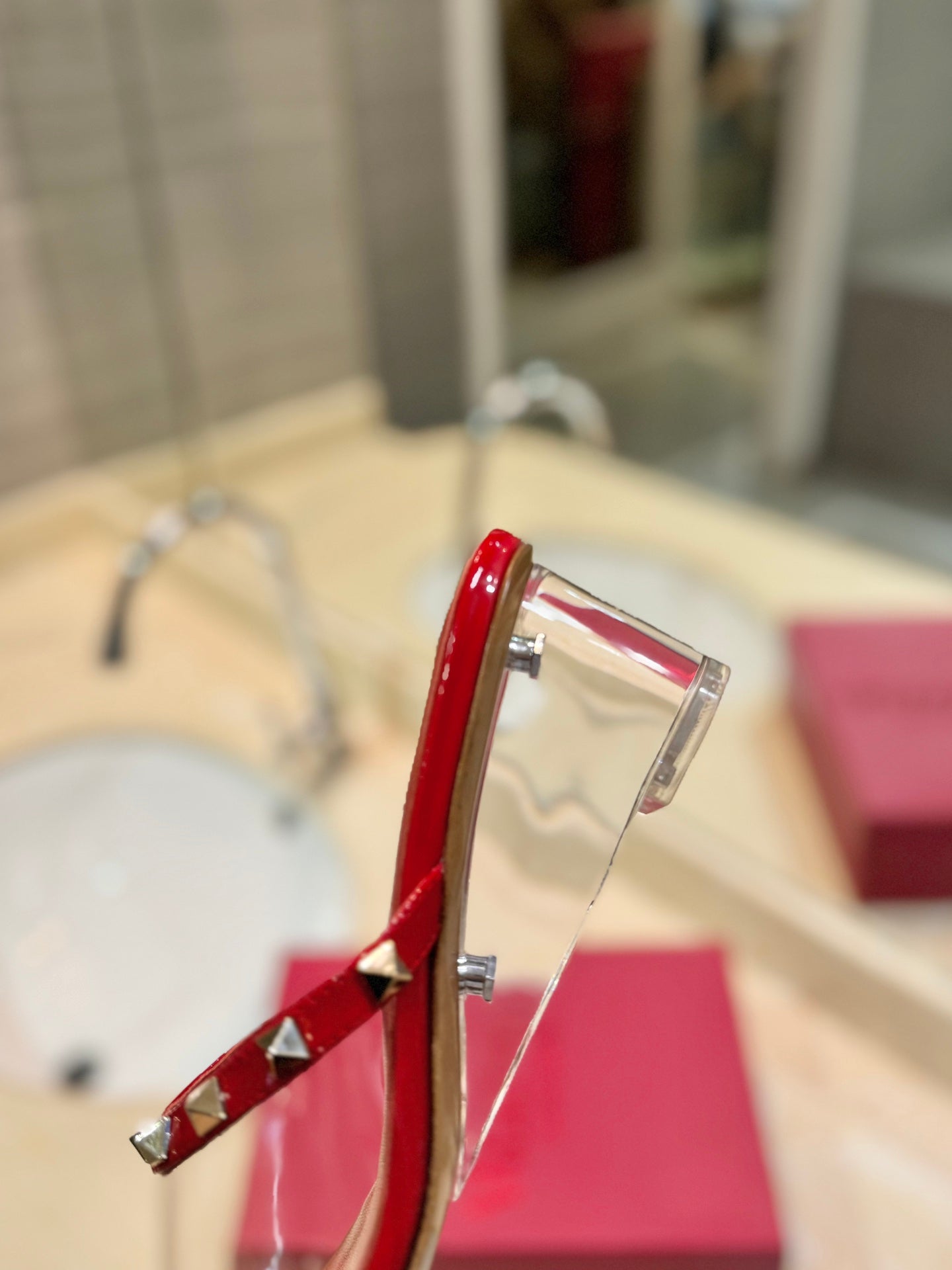 ROCKSTUD MULE SANDALS IN CHERRY RED CALFSKIN AND TRANSPARENT PVC FILM