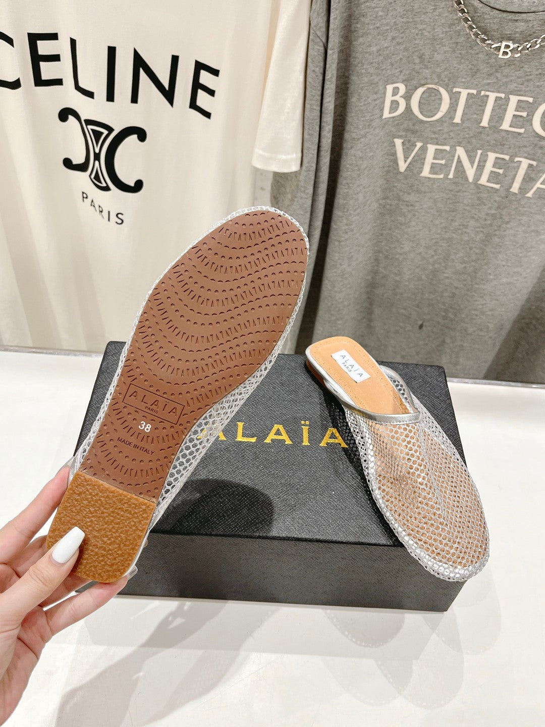 ALAIA FLAT MULES IN SILVER MESH FISHNET