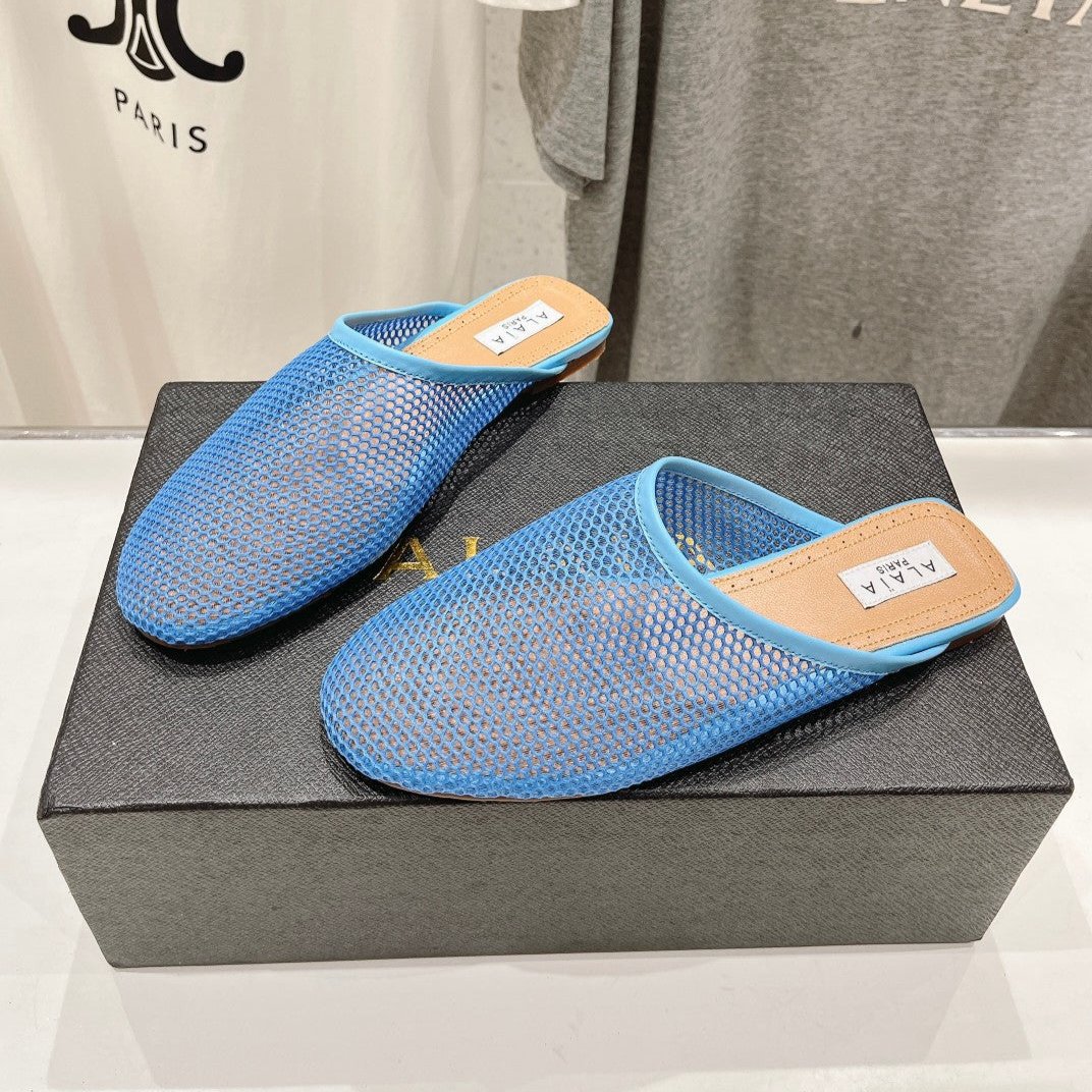 ALAIA FLAT MULES IN CERULEAN BLUE MESH FISHNET