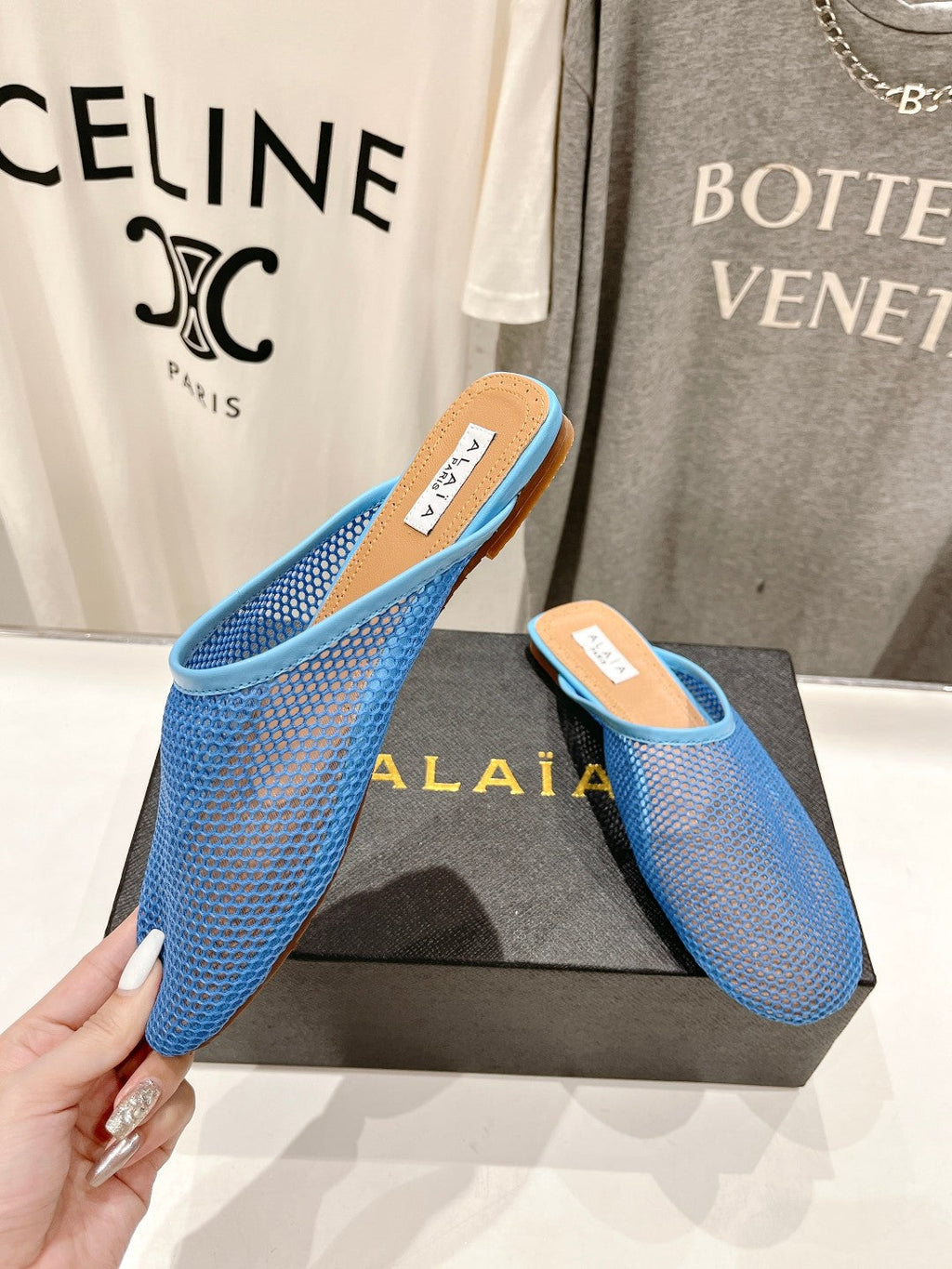 ALAIA FLAT MULES IN CERULEAN BLUE MESH FISHNET