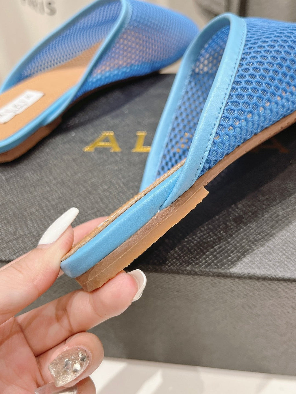 ALAIA FLAT MULES IN CERULEAN BLUE MESH FISHNET