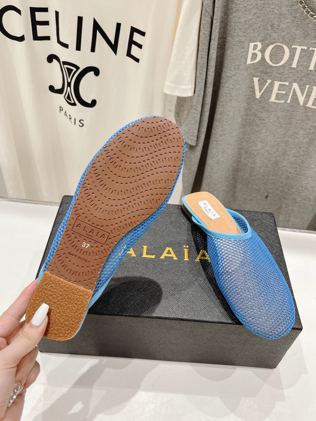 ALAIA FLAT MULES IN CERULEAN BLUE MESH FISHNET