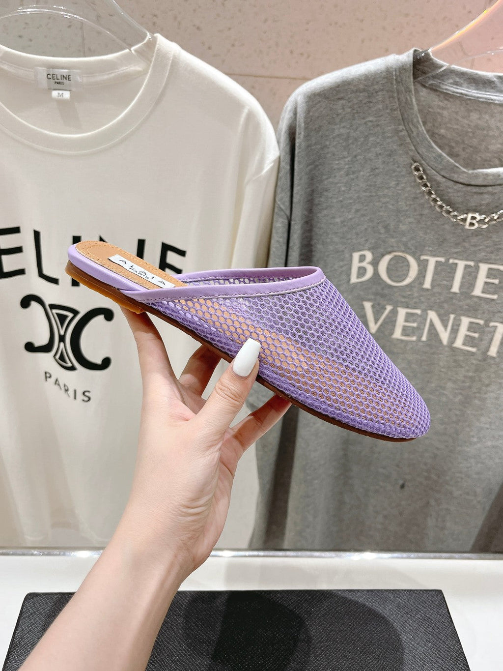 ALAIA FLAT MULES IN LIGHT PURPLE MESH FISHNET