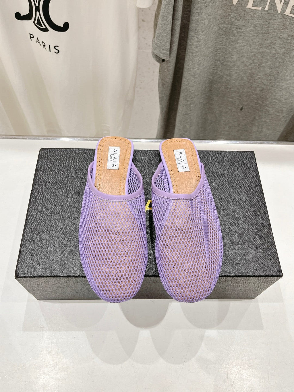 ALAIA FLAT MULES IN LIGHT PURPLE MESH FISHNET