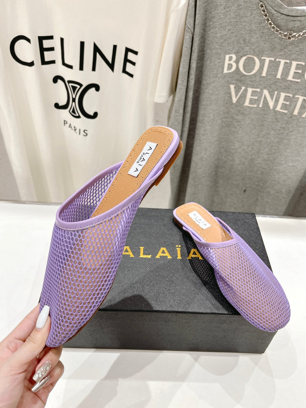 ALAIA FLAT MULES IN LIGHT PURPLE MESH FISHNET