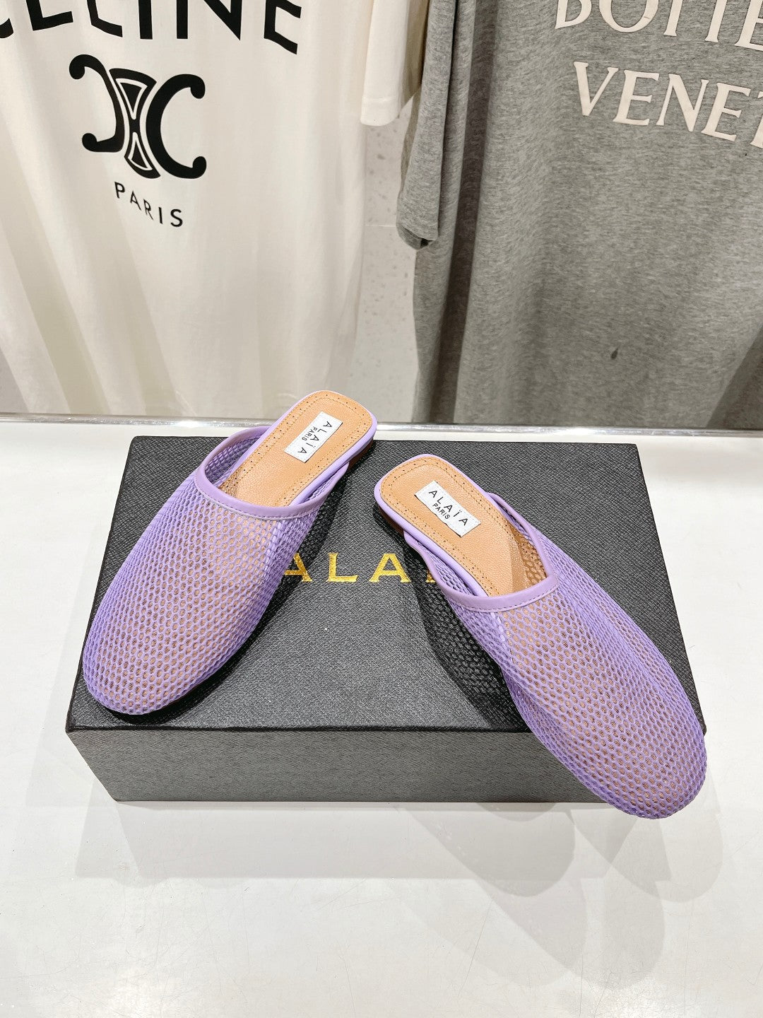 ALAIA FLAT MULES IN LIGHT PURPLE MESH FISHNET