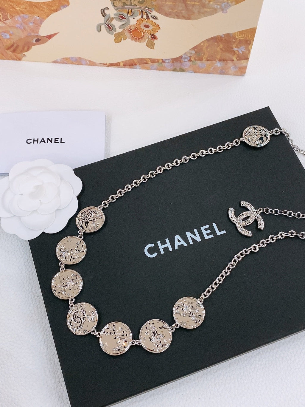 TWISTED CHAIN BELT WITH RHINESTONES AND LOGO PLATE IN SILVER TONE