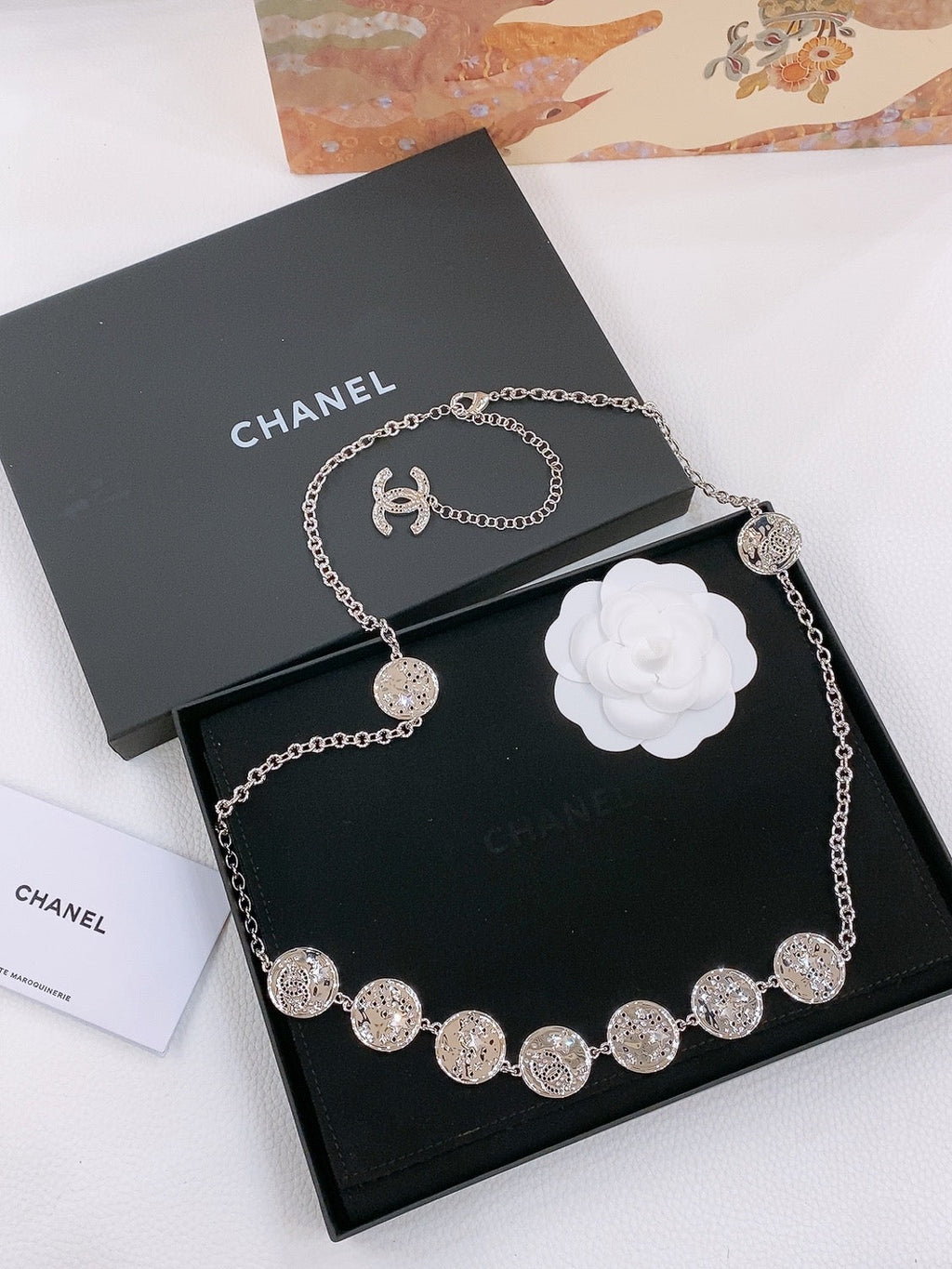 TWISTED CHAIN BELT WITH RHINESTONES AND LOGO PLATE IN SILVER TONE