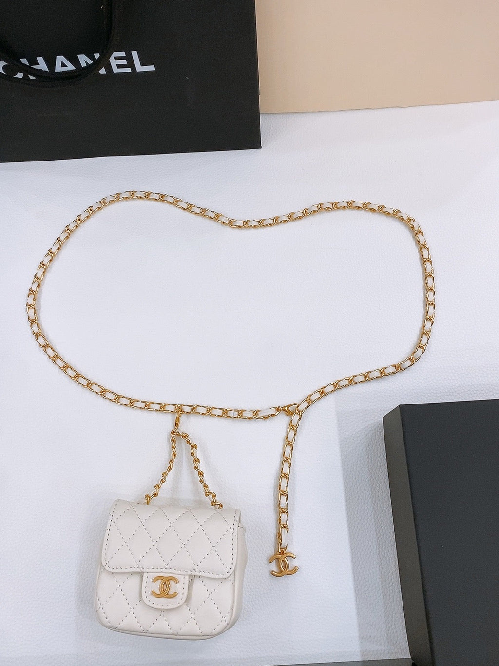 CHAIN BELT WITH GOLD METAL WHITE CALFSKIN INTERLINKING STRAPS AND MINI BAG ATTACHMENT