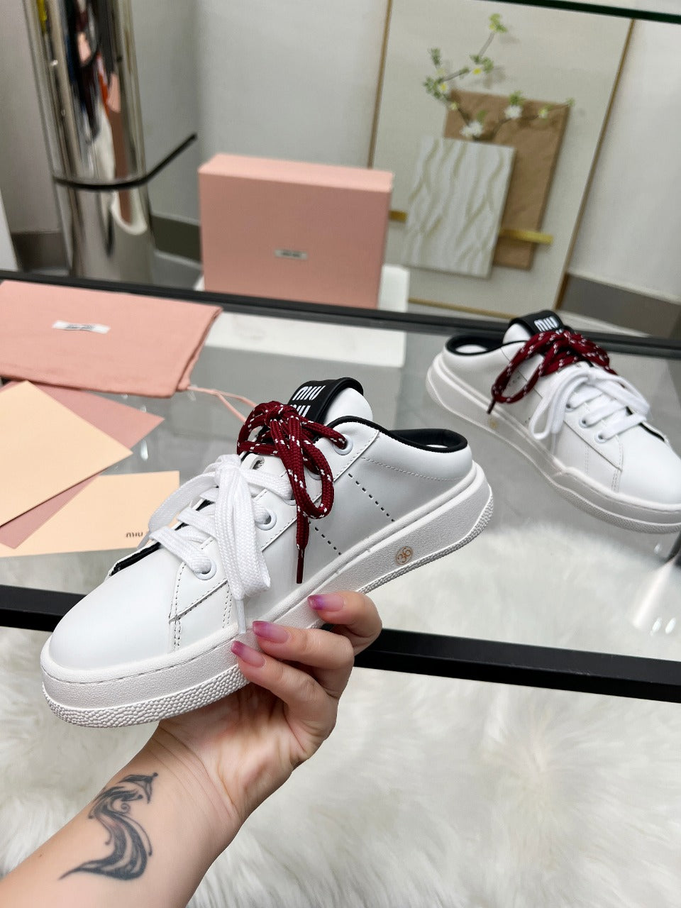 SNEAKER MULES IN BLACK AND WHITE CALFSKIN WHITE RED LACES